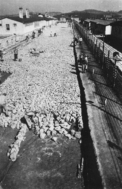 Forced laborers work on the stone foundation of the roll call area in Mauthausen